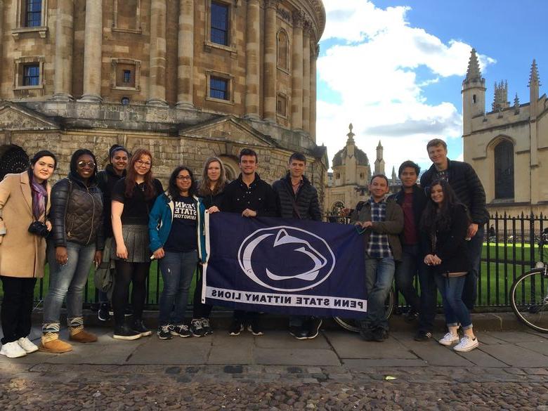Group of students holding Penn State Flag in England 